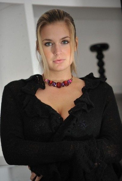 young blonde girl posing in clothes at home