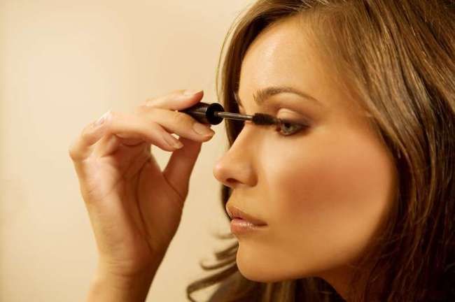 brunette girl having a makeup in the dressing room