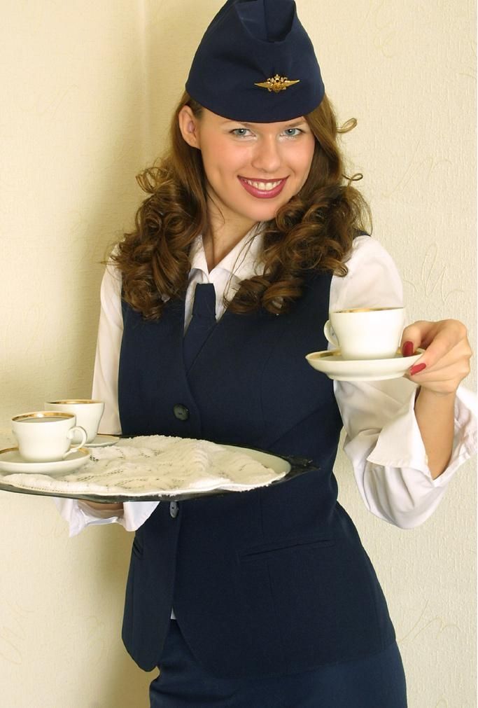 curly brunette girl strips from the stewardess uniform