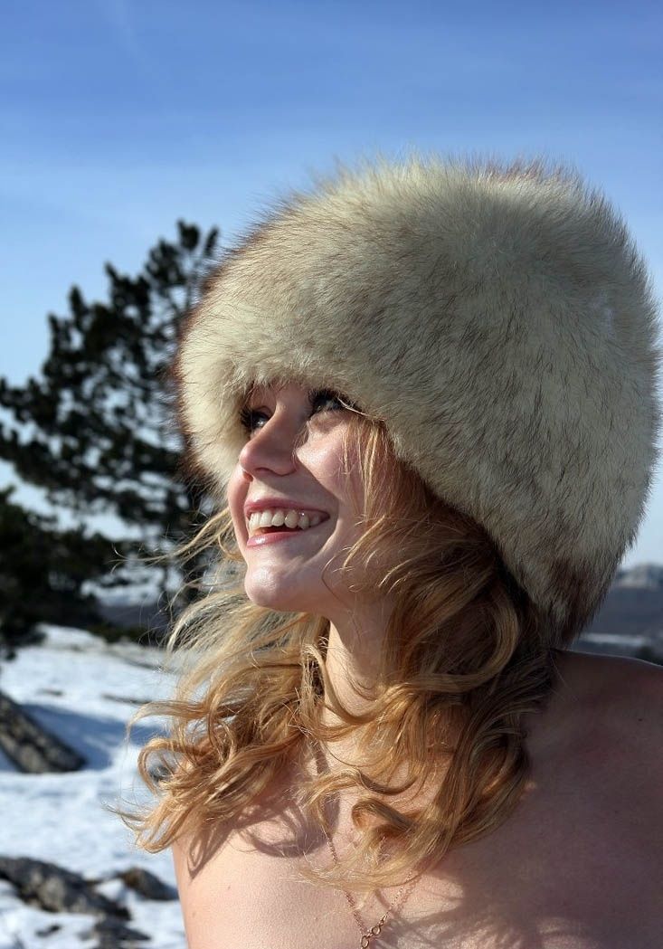 blonde girl wearing fur clothing in the winter