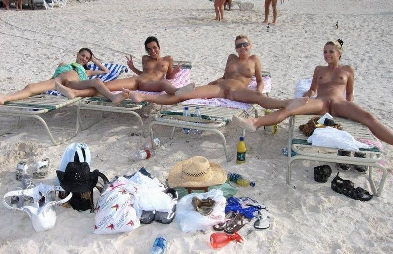 young girls taking pictures on the beach