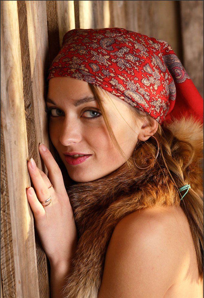 young blonde girl wearing headscarf in the barn