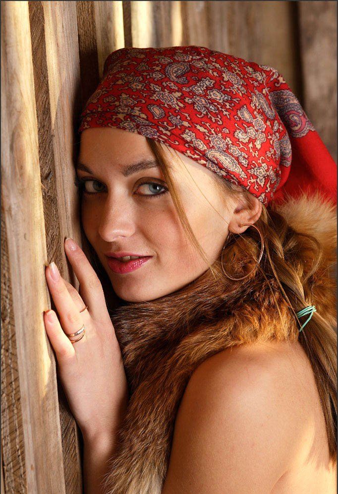 young blonde girl wearing headscarf in the barn