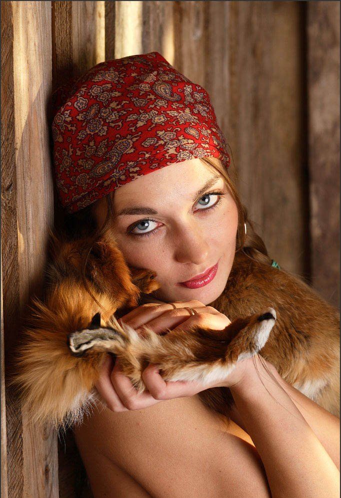 young blonde girl wearing headscarf in the barn