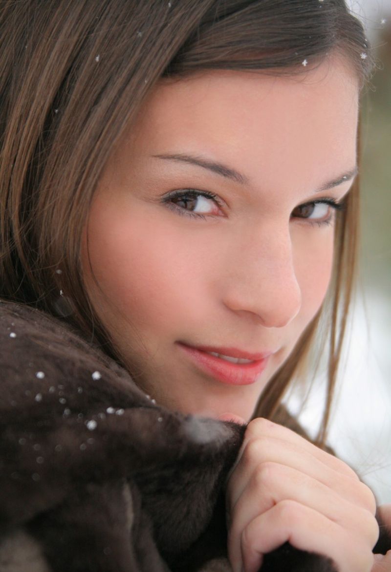 cute young brunette girl posing in boots outside in the winter