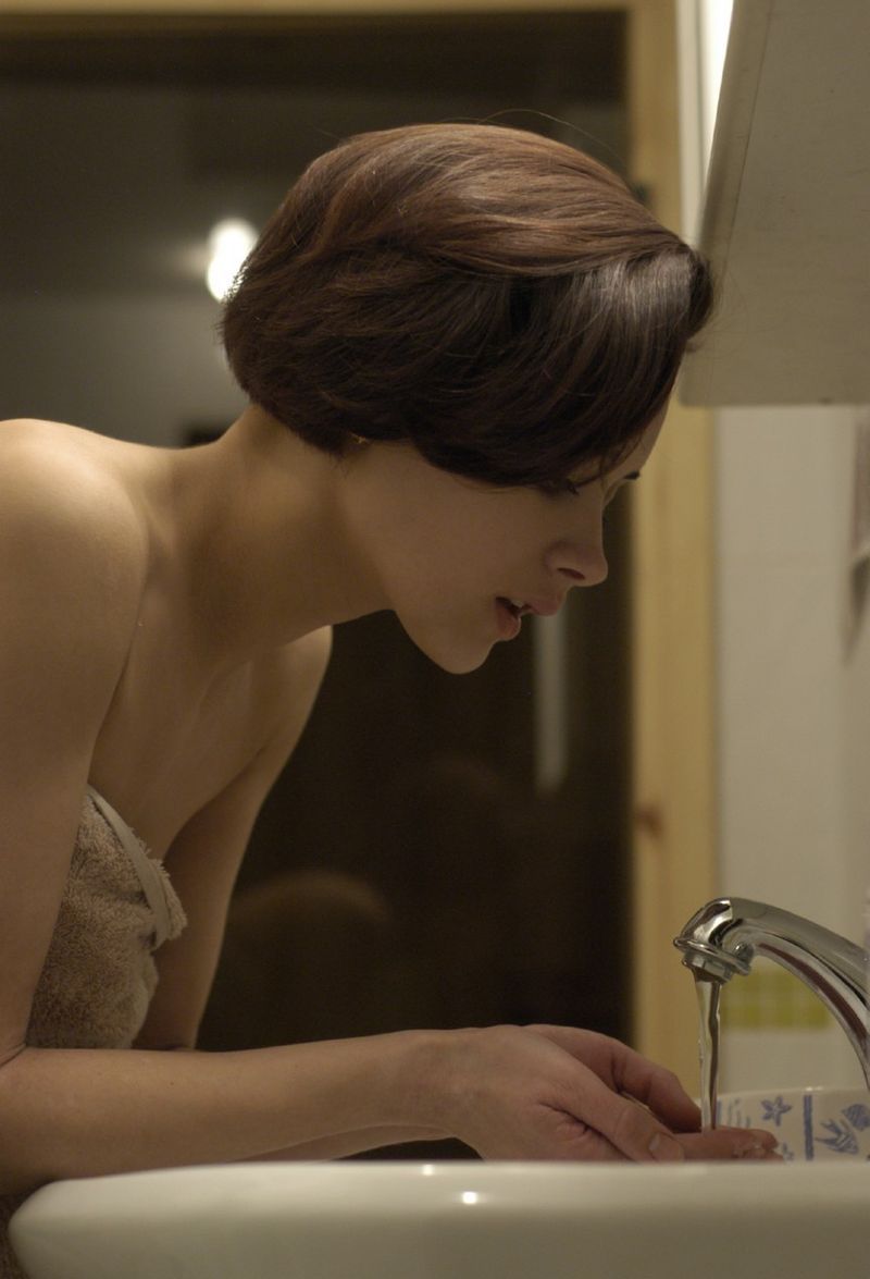 brunette girl in the bathroom with a towel