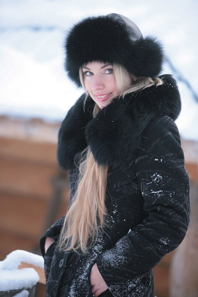blonde girl wearing black coat in the winter