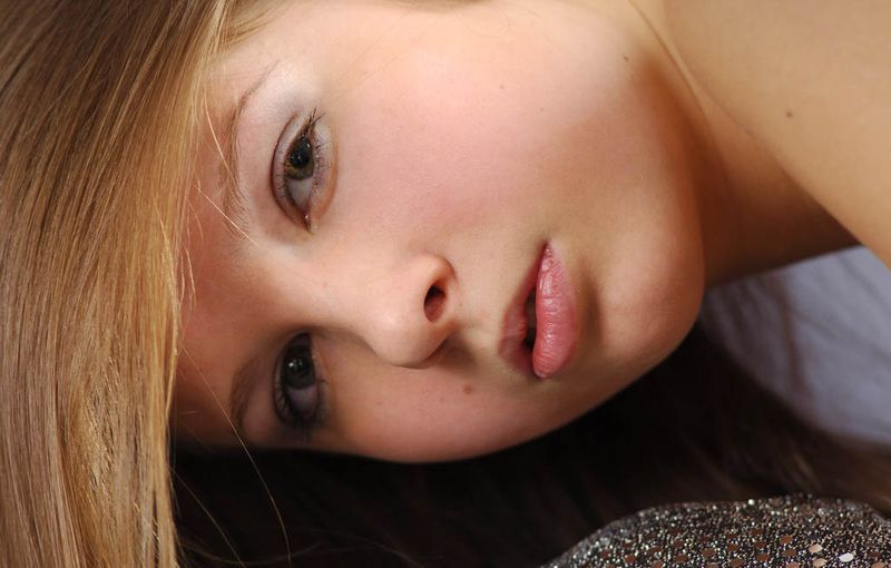 young blonde girl wearing silver dress outfit