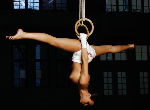 brunette girl doing gymnastic exercises