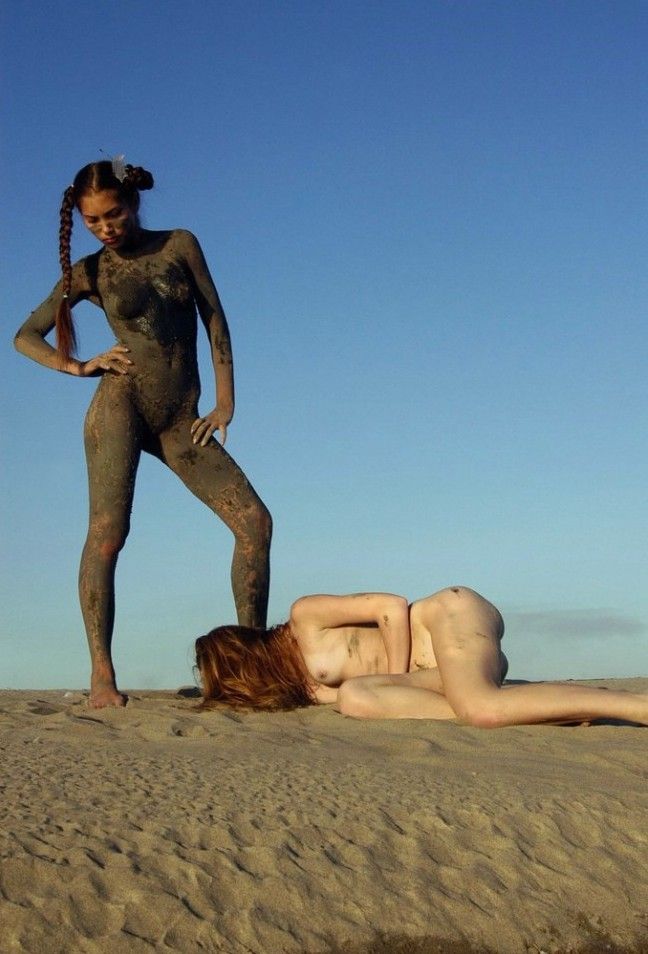 two young dirty girls show off on the sand