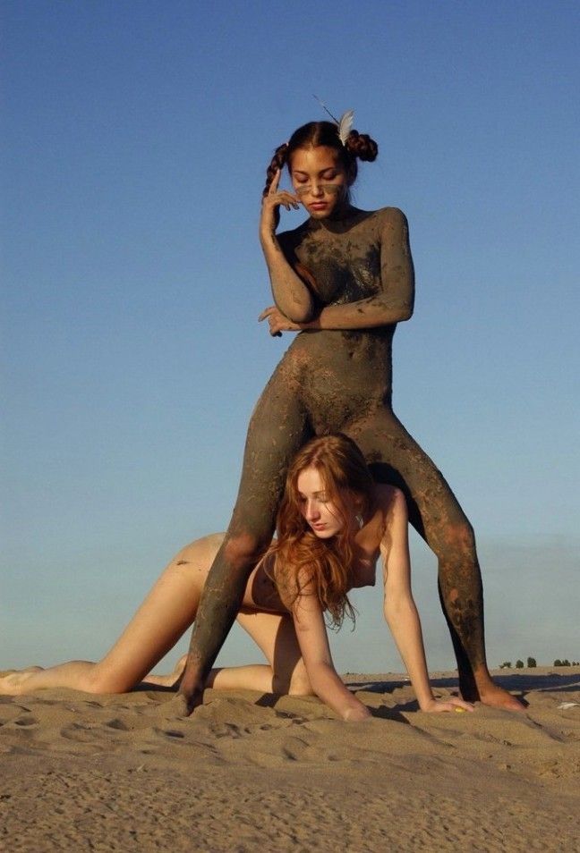 two young dirty girls show off on the sand