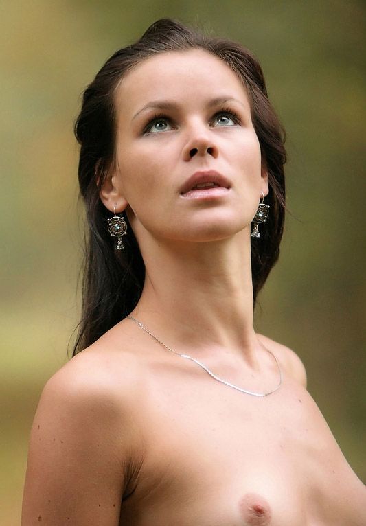 young black haired girl outside in the autumn forest