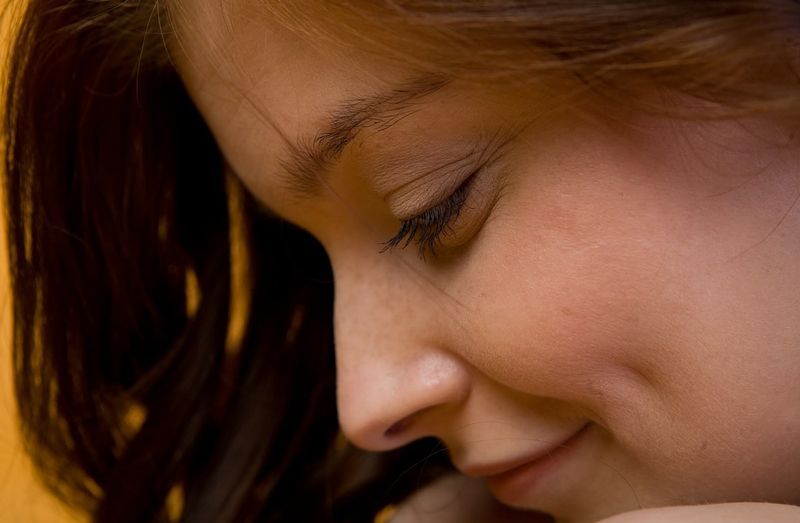 cute young curly red haired girl posing in the studio