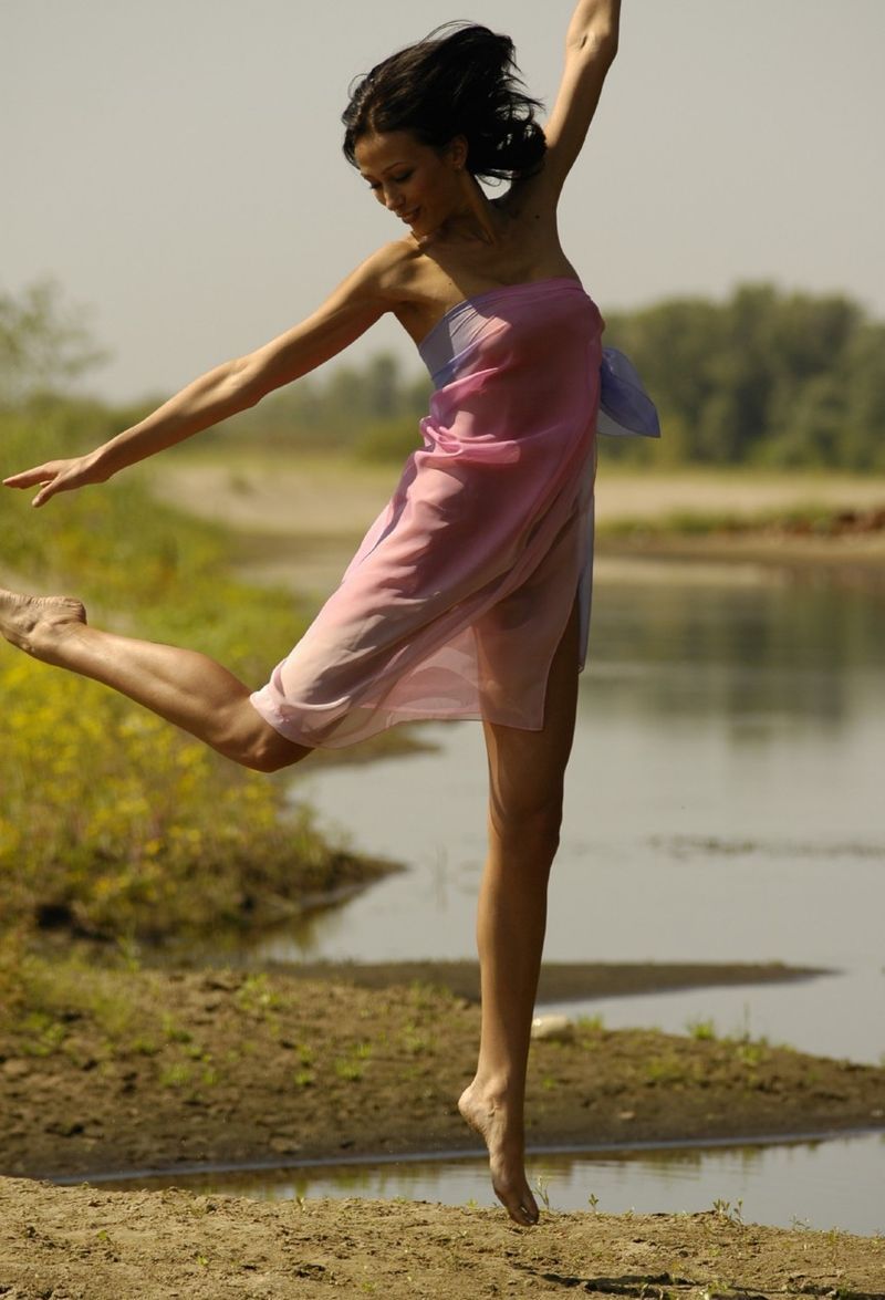 young brunette girl shows off with a pretty scarf at the river