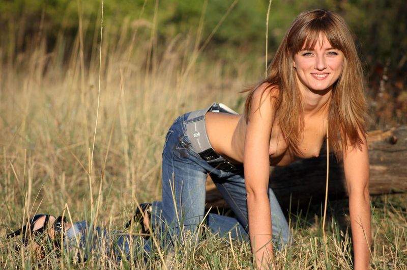 blonde girl shows off outside on the field