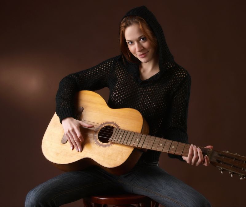 cute young red haired girl reveals with the guitar