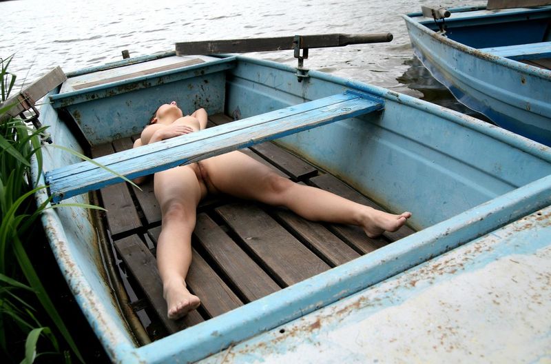 brunette girl posing in the old boat