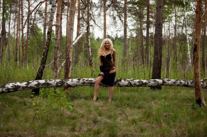 swedish blonde girl strips her clothes in the forest