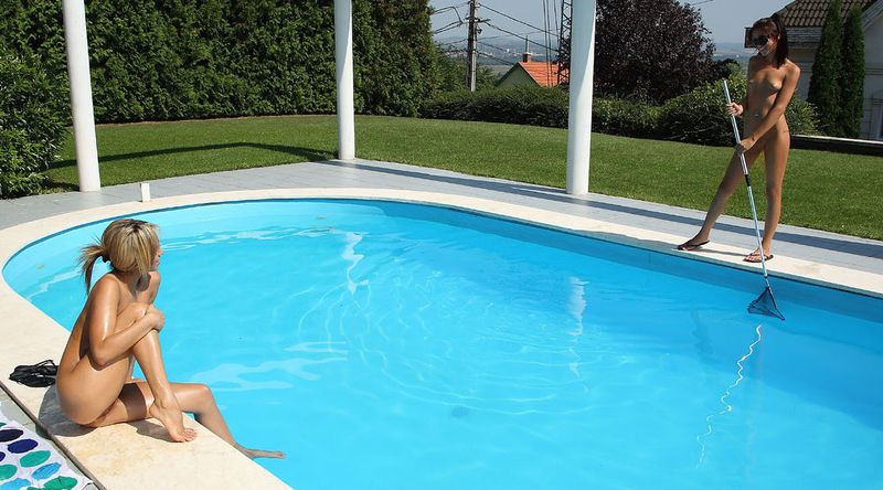 blonde girl on the towel strips her bikini and sunbathing at the swimming pool