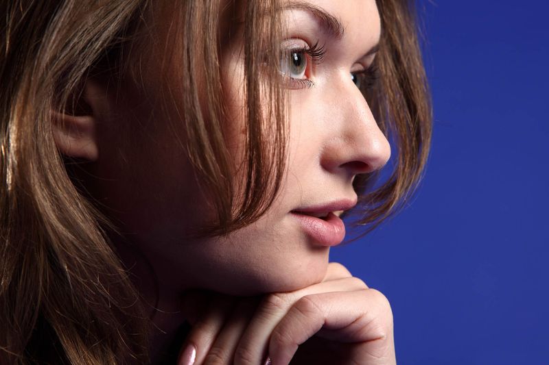 young brunette girl in the studio with a stool seat