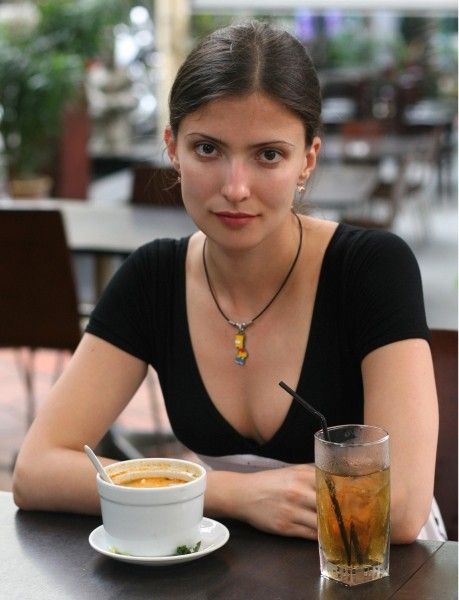 young brunette girl in front of the camera outside in the nature