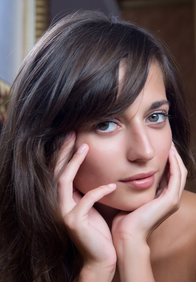 cute young brunette girl with bracelets posing on stairs and in the bathroom while at home