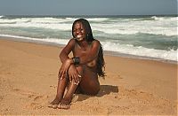 Babes: black girl with long hair posing on the beach