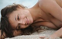 Babes: young curly brunette girl on the beach in the sand