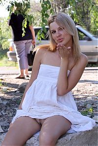 Babes: young blonde girl reveals in a white dress and black boots by the road