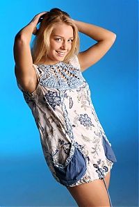 Babes: cute young blonde girl with blue eyes reveals in the blue studio with textiles