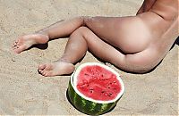 Babes: young blonde girl on the beach eating a watermelon