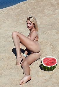 Babes: young blonde girl on the beach eating a watermelon