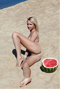 Babes: young blonde girl on the beach eating a watermelon