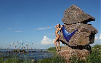 Babes: young dark blonde girl on rocks with a blue scarf