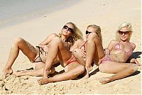 Babes: three young blonde girls wearing extreme bikini on the beach