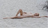 Babes: young blonde girl undresses on the beach