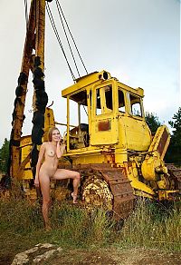 Babes: young blonde girl on the old yellow excavator