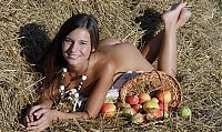 Babes: cute young brunette girl in the hay with apples
