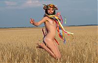 Babes: young brunette girl with a flower wreath on the wheat field