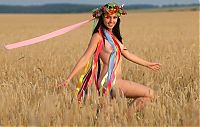 Babes: young brunette girl with a flower wreath on the wheat field