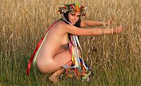 Babes: young brunette girl with a flower wreath on the wheat field