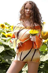 Nake.Me search results: young curly brunette girl in the field of sunflowers