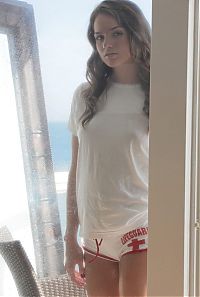 Babes: cute young brunette girl lifeguard in the house built on the sea