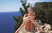 Babes: young blonde girl on rocks above the sea