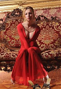 Babes: blonde girl wearing red dress on the antique couch