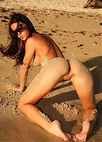 Babes: young brunette girl wearing sunglasses on the beach