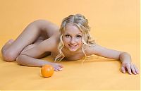 Babes: young blonde girl with the orange fruit