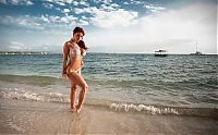 Babes: red haired girl strips her swimsuit in the sea