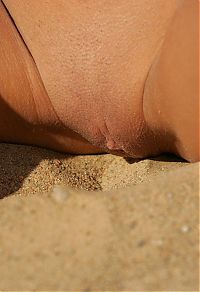 Babes: cute young brunette girl in the sand at the river in saint petersburg