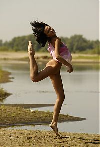 Nake.Me search results: young brunette girl shows off with a pretty scarf at the river